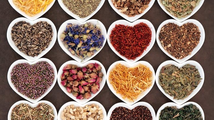 Heart-shaped dishes of different herbs and spices